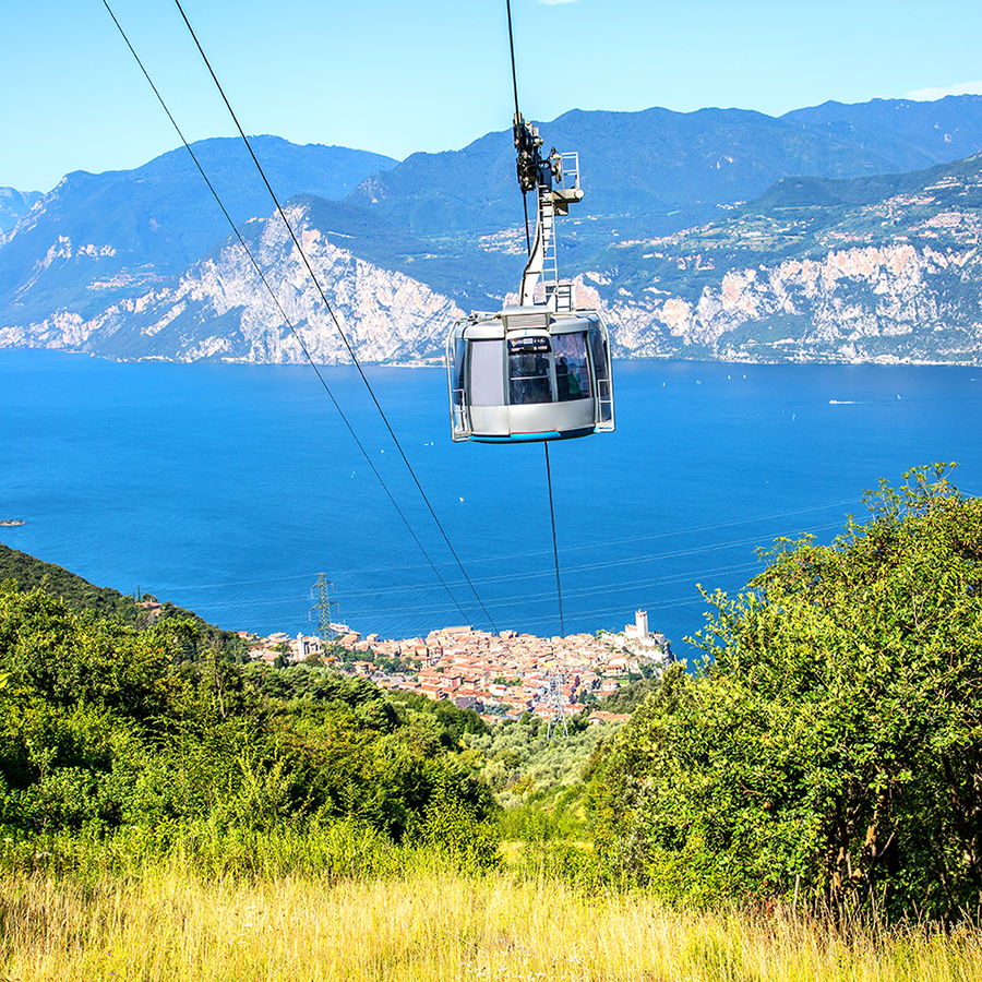 Prà Alpesina Chairlift - Upper terminal in Italy - a large body of water.