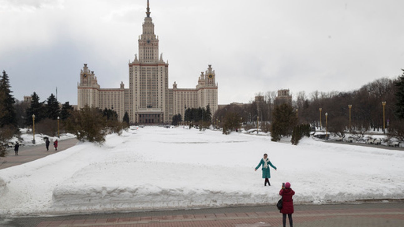 Vorob'yevy gory in Russia: a woman walks in front of the russian parliament building in moscow.