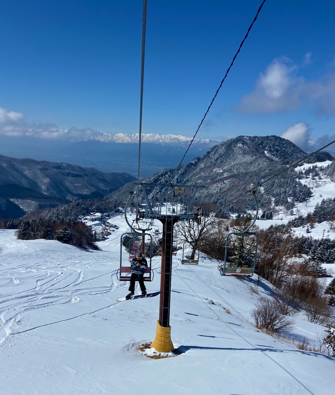 Yamaboku – Yamada Bokujo in Japan - a ski lift going up a snowy hill.