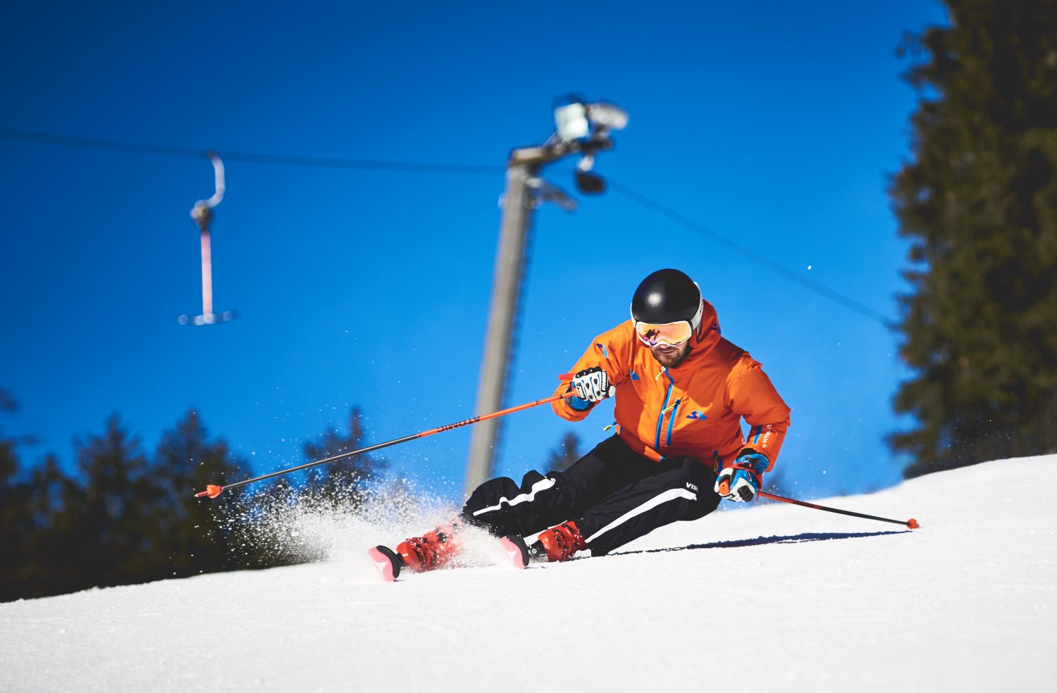 Bílá in Czech Republic - a man in an orange jacket skiing down a hill.