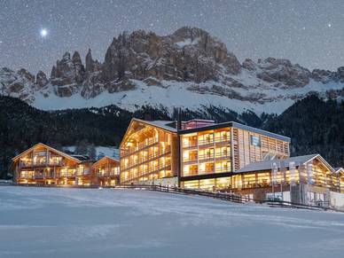 Winter scene at Manba Ski Resort in Kansai, Japan, featuring a lodge and chalet amidst pristine snowy landscape, bustling with winter sport activities.