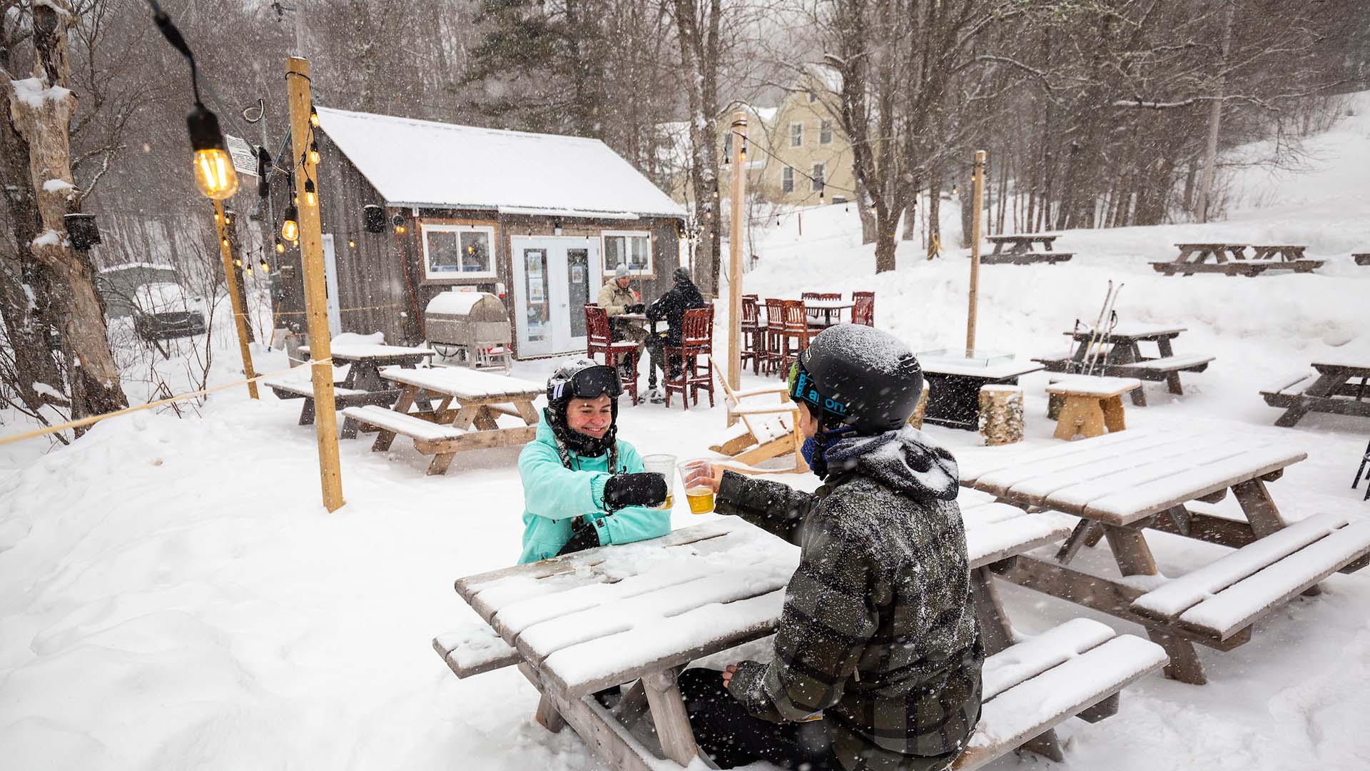 Wentworth in Canada - two people sitting at a picnic table in the snow.
