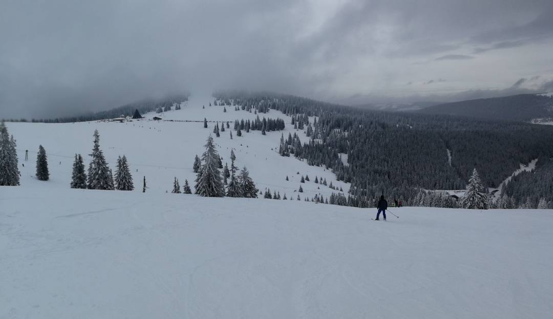 Șureanu in Romania - a person skiing down a snow covered mountain.