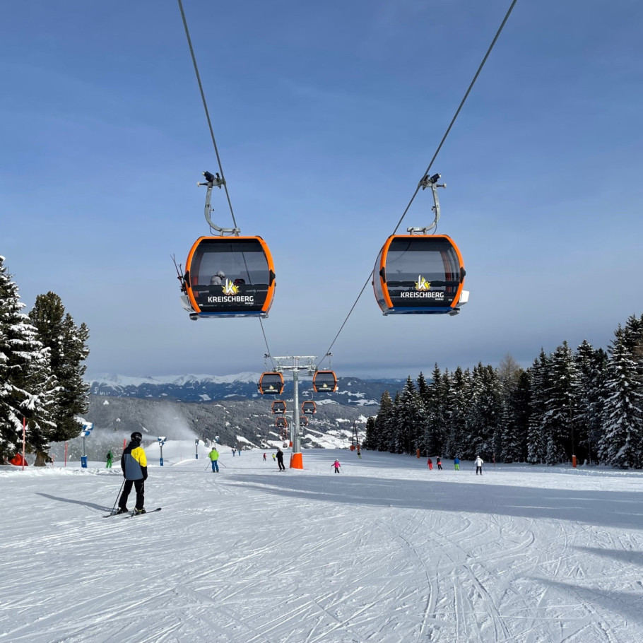 Kreischberg in Austria - a couple of people riding a ski lift.