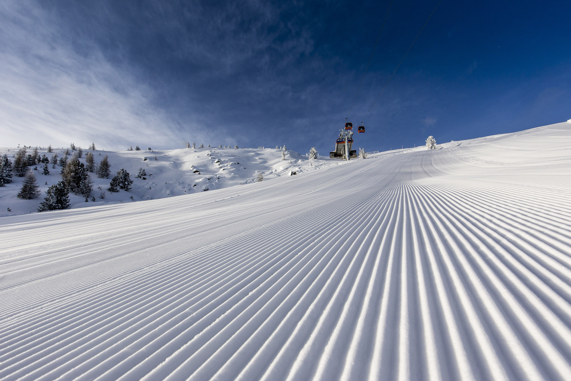 A skier enjoying a day at the Kreischberg ski resort in Murtal, Styria, Austria. The picturesque scene features a charming challet and snow-covered slopes.