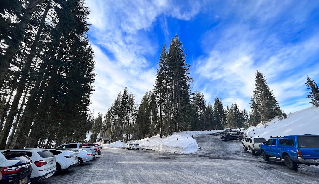 Winter sports scene at Badger Pass in Yosemite National Park, California, featuring a ski resort nestled in stunning winter scenery with snowy mountains and trees.