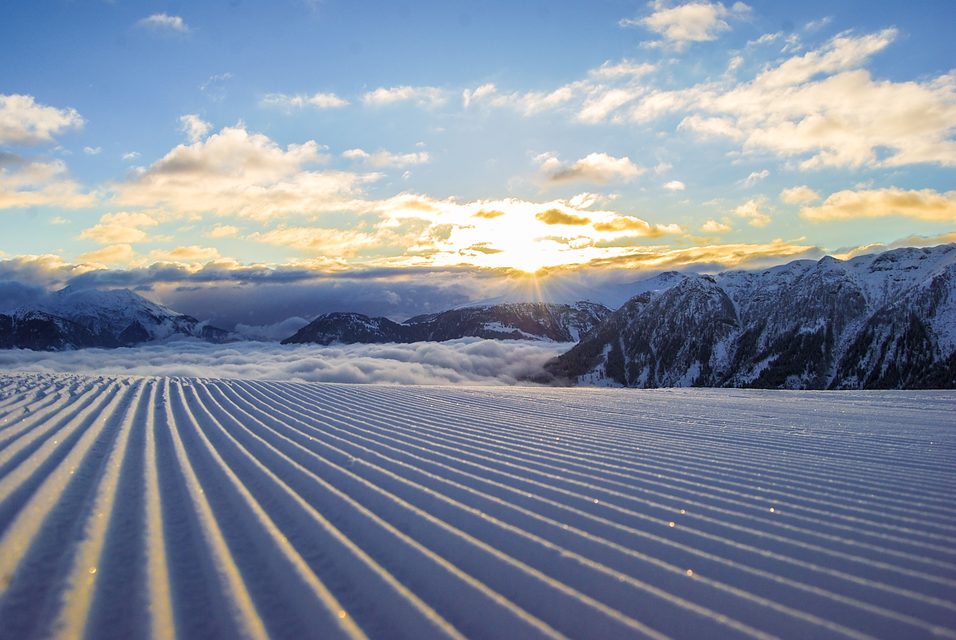 A skier enjoying the winter sports scene at Tschappina-Lüsch-Urmein ski resort in Eastern Switzerland, amidst the splendid winter scenery.