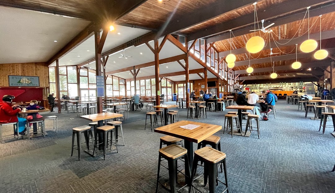 View of Mohawk Mountain featuring a prominent lodge, in Cornwall, Connecticut. This winter scene also suggests presence of a ski resort and various winter sports facilities.