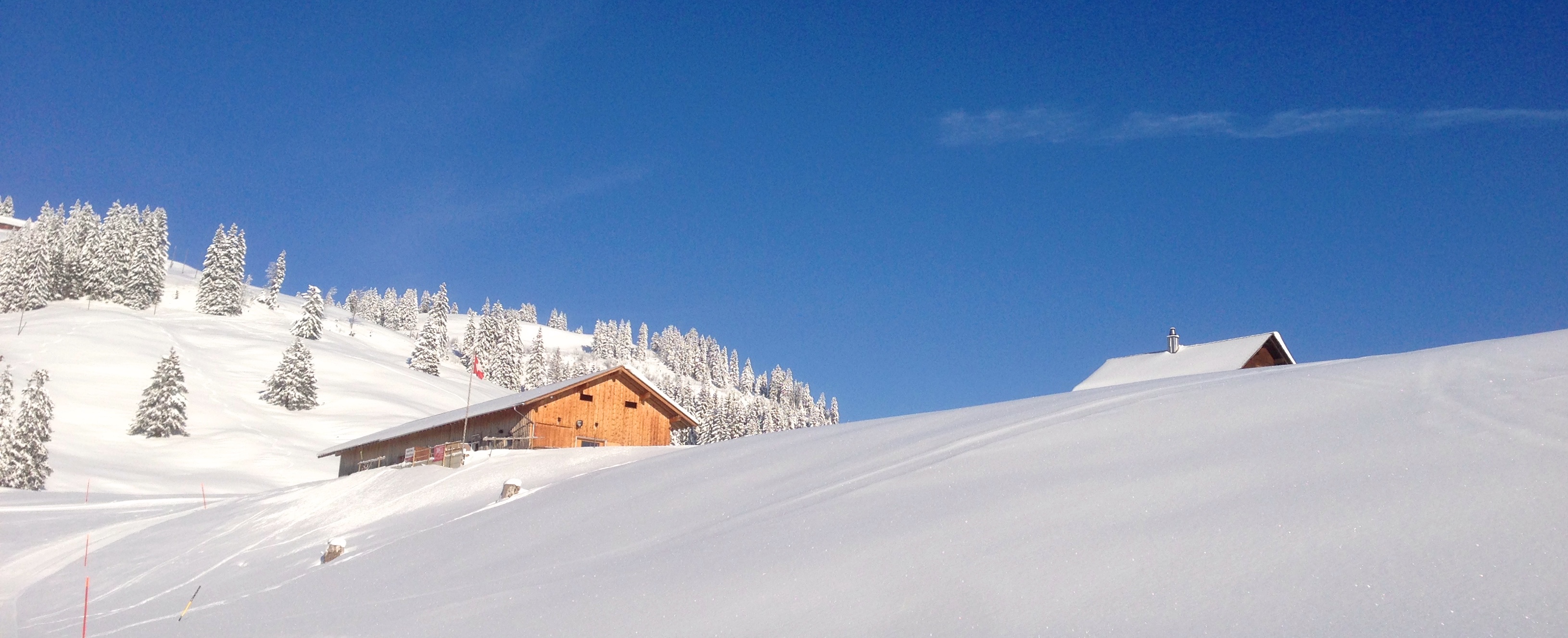 A charming chalet and mountain hut nestled in the stunning winter scenery of Brunni-Bahnen in Engelberg-Titlis, Switzerland. A scenic vista full of winter sports activities.