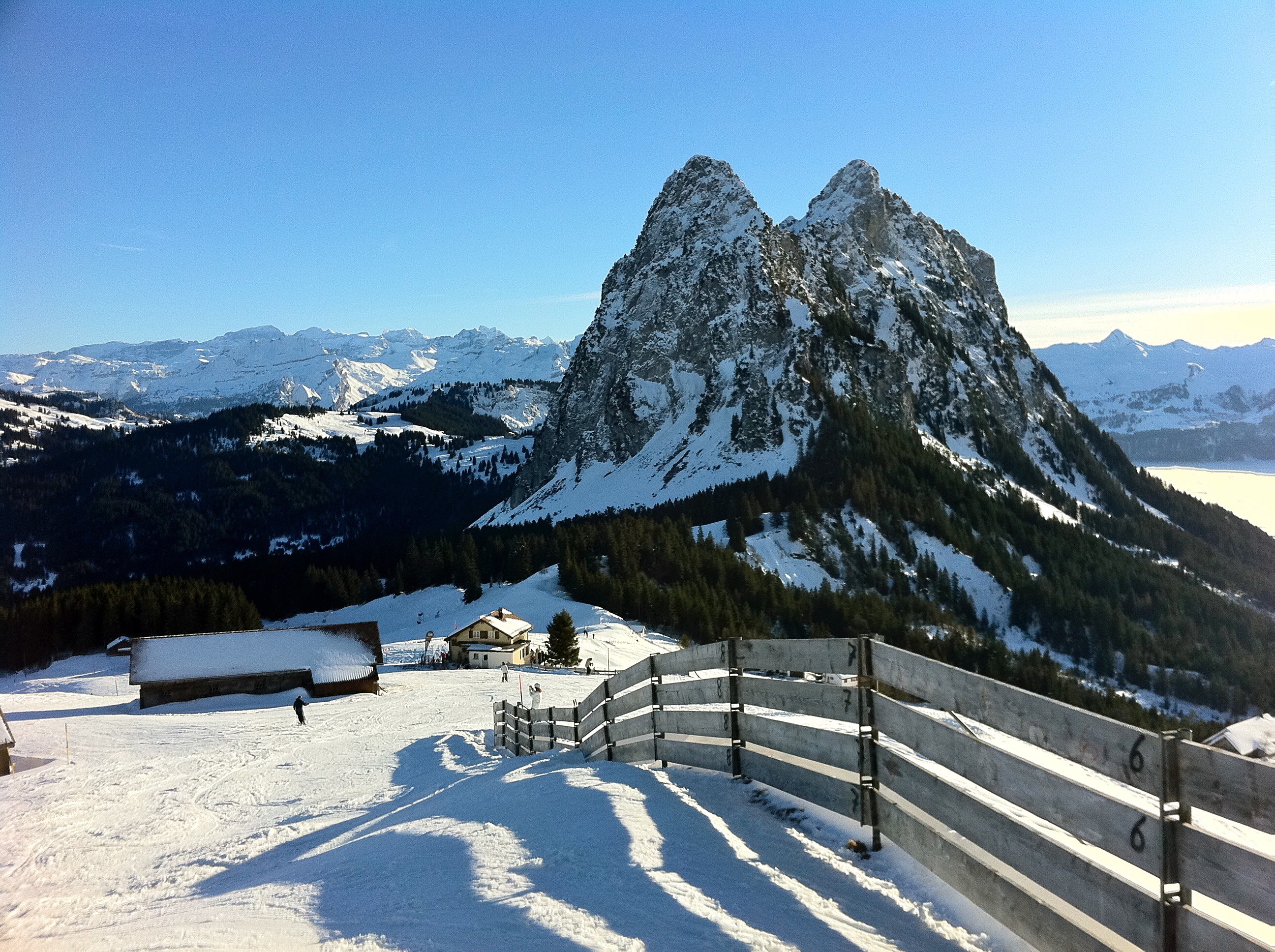 Winter sports scene at Brunni-Bahnen in Engelberg-Titlis, featuring stunning winter scenery with mountains. A bustling winter sports centre in the heart of Central Switzerland.