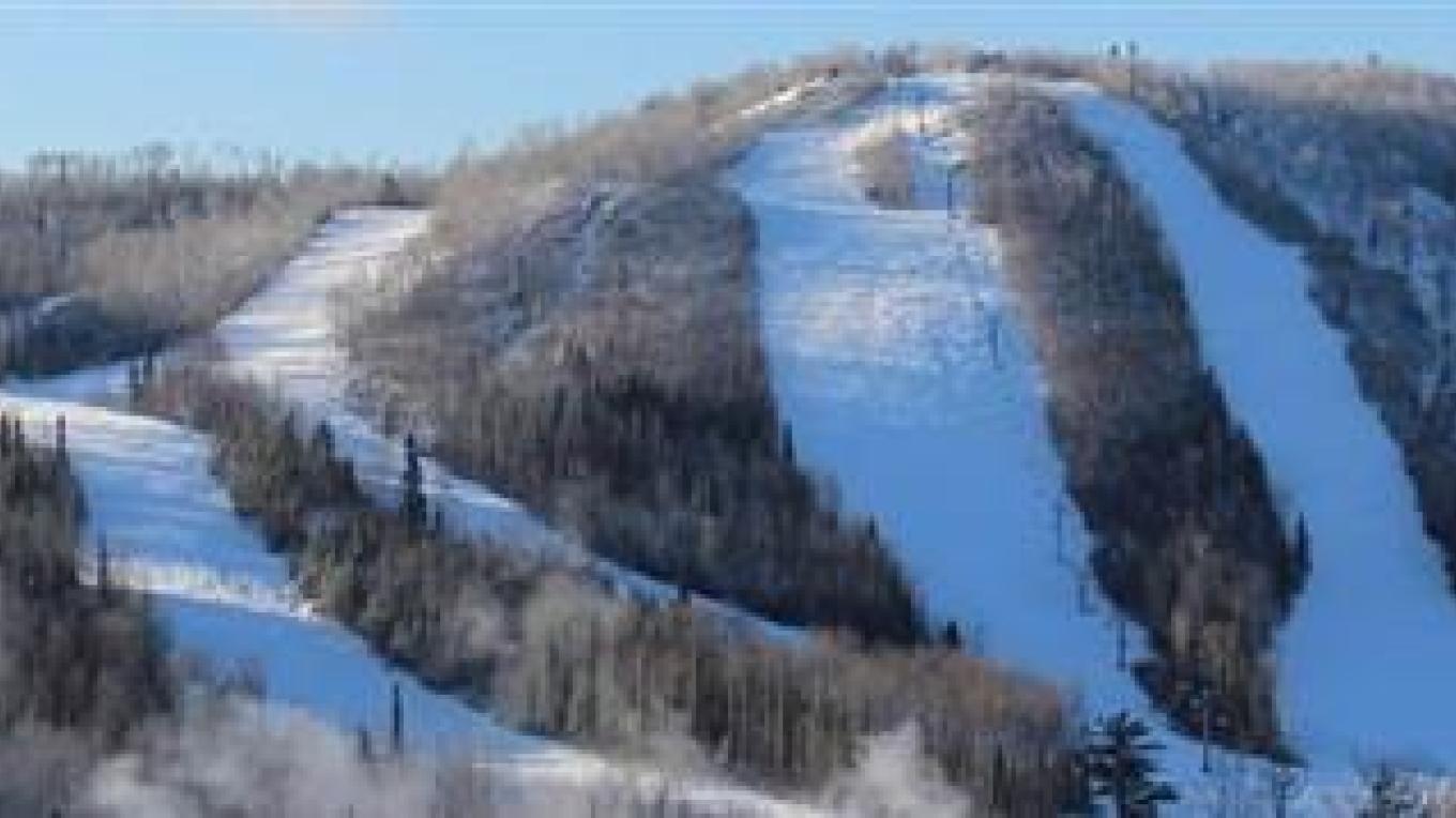 Loch Lomond in Canada - a snow covered mountain with trees in the background.