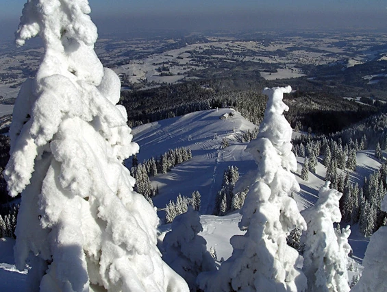 View of the stunning Grüntenlifte – Kranzegg ski resort in Bavaria Germany featuring snow-covered slopes ski lift and skiers packed with winter sports fun.