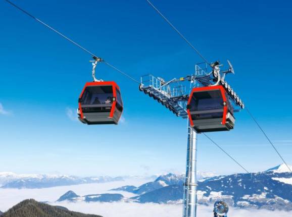Ski lift at the charming Grüntenlifte – Kranzegg ski resort in Bavaria, Germany. A skier is enjoying the winter sports scene next to a wooden challet.