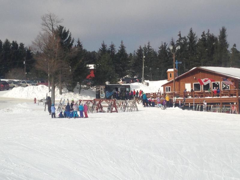 Winter sports scene at a ski resort in Buffalo, Greater Niagara, Colden, New York, featuring a ski lift, a chalet, and a winter sports centre.