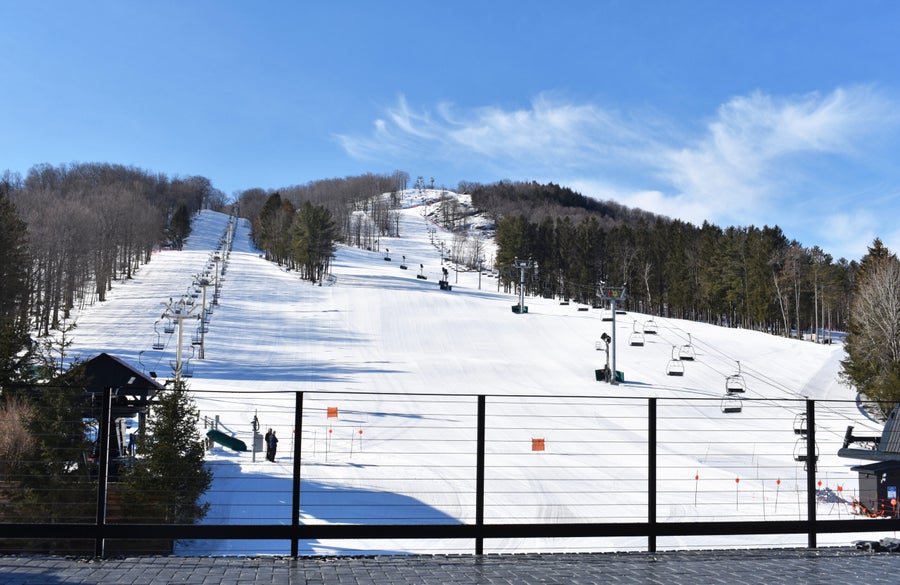 Winter sports scene at Bousquet ski resort in Pittsfield, Massachusetts, featuring a ski lift and snow-covered slopes.