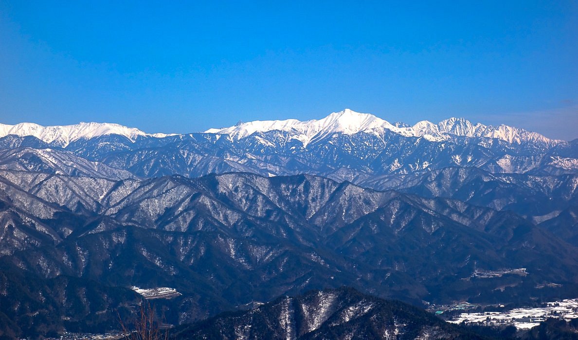 Hida Kawai in Japan - a view of snow covered mountains from the top of a mountain.