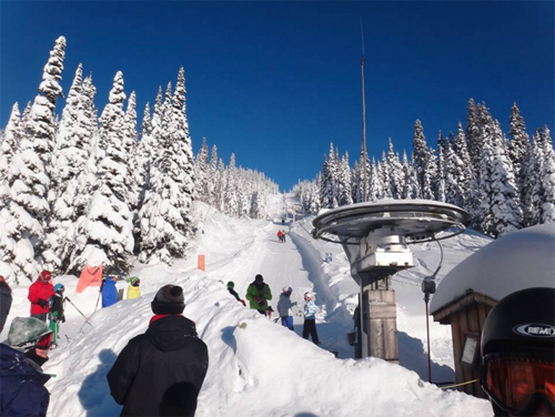 A ski resort scene at Troll Ski in Quesnel, British Columbia, showcasing a ski lift with a stunning winter landscape, promoting an active winter sports environment.