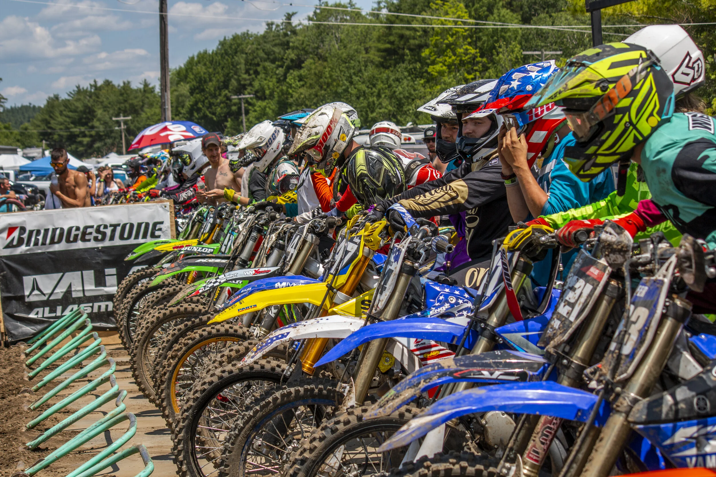 A sunlit chalet overlooks Royal Mountain in Capital-Saratoga, Johnstown, New York, with a mountain bike and a snowmobile parked nearby, hinting at possible winter sports activities.