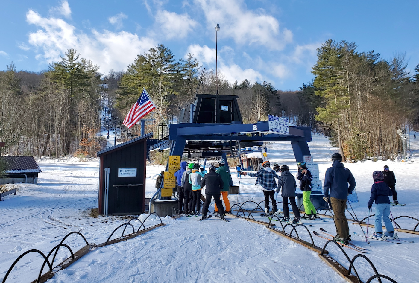 Royal Mountain in USA - a group of people standing around a ski lift.