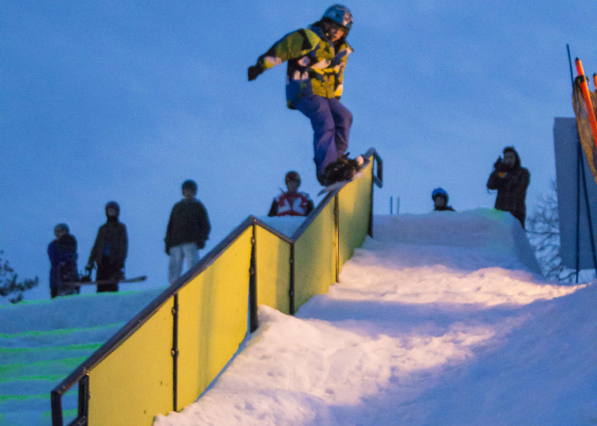 Big Bear at Masthope Mountain in USA - a snowboarder doing a trick on a ramp.