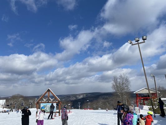 Winter sports scene at Big Bear in Masthope Mountain, Pennsylvania featuring a ski resort amidst stunning winter scenery, with a ski lift predominating the scene.