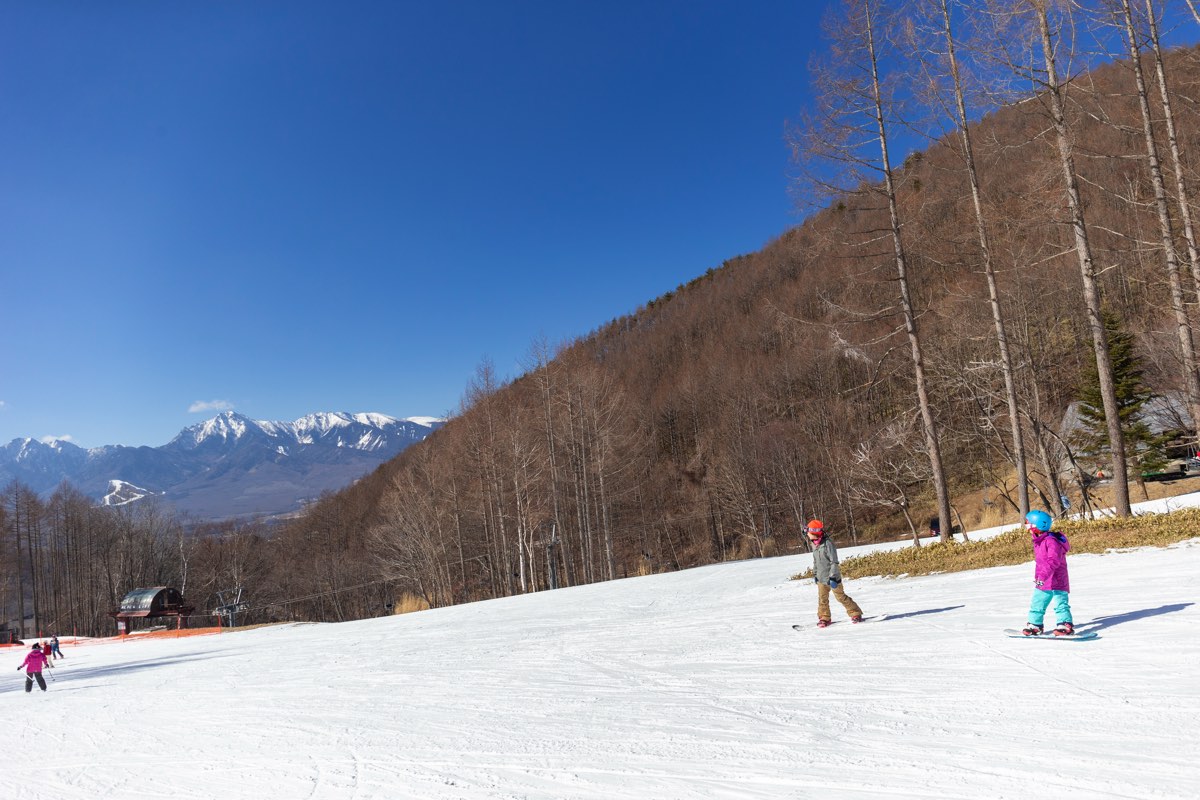 Chateraise Ski Valley Nobeyama in Japan - a group of people skiing down a snow covered slope.