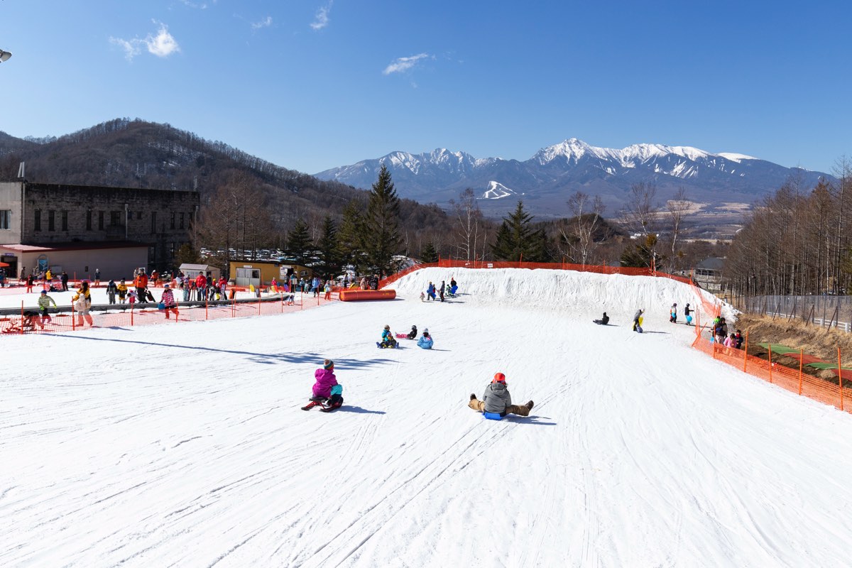 Chateraise Ski Valley Nobeyama in Japan - a group of people skiing down a slope.