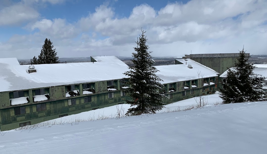 Ski resort on Big Moose Mountain, Maine with a charming chalet, a bustling winter sports centre and a lodge, all enveloped in the breath-taking winter scenery.