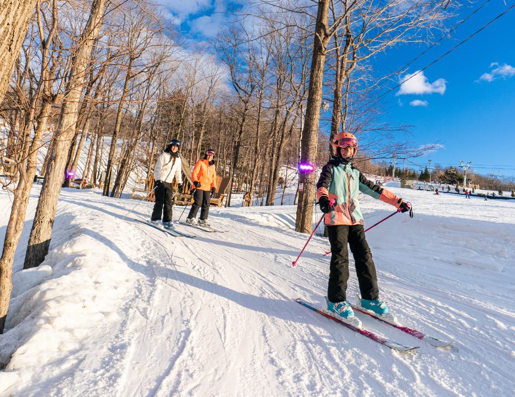Ski Saint-Bruno in Canada - a group of people skiing down a snow covered slope.