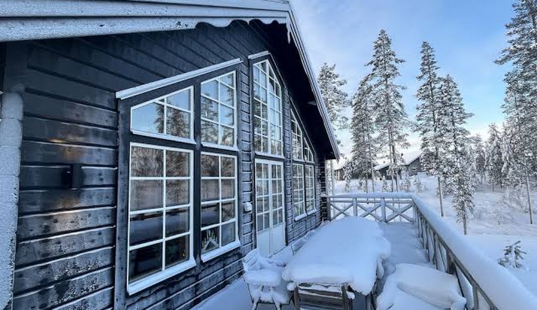 Winter scene at Idre Himmelfjäll, Sweden showcasing the bustling winter sports center nestled amidst the magnificent frozen landscape, featuring a welcoming lodge for resort guests.