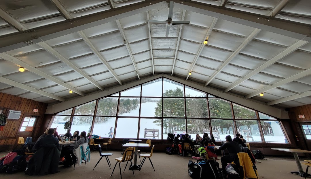 View of Snow Ridge in Turin, New York, featuring a bustling winter sports centre amidst a picturesque winter landscape.