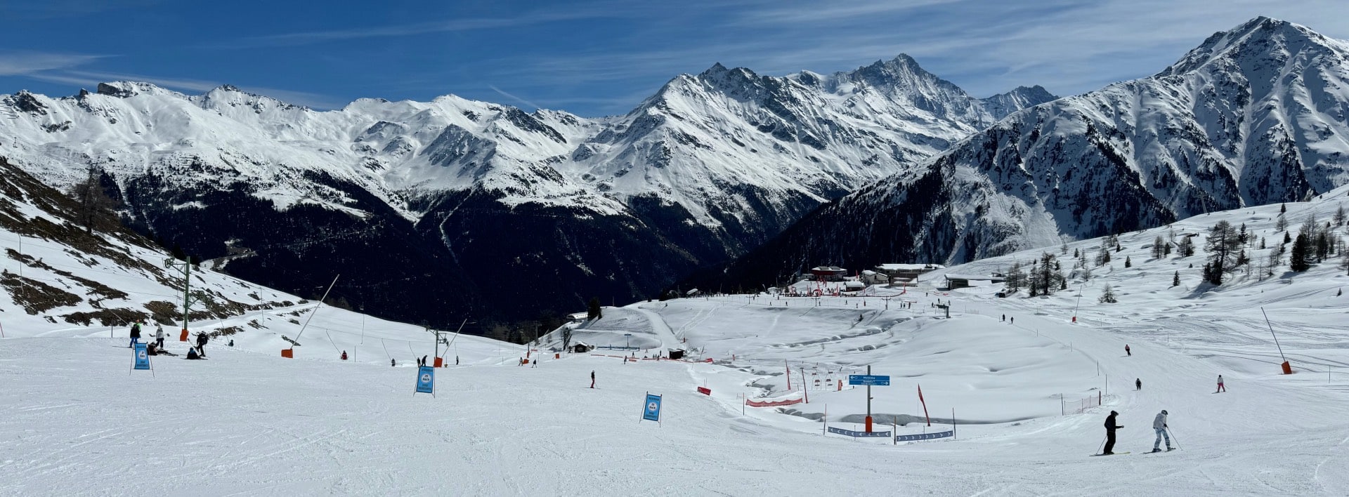 Grimentz Zinal in Switzerland - a group of people skiing down a snowy slope.