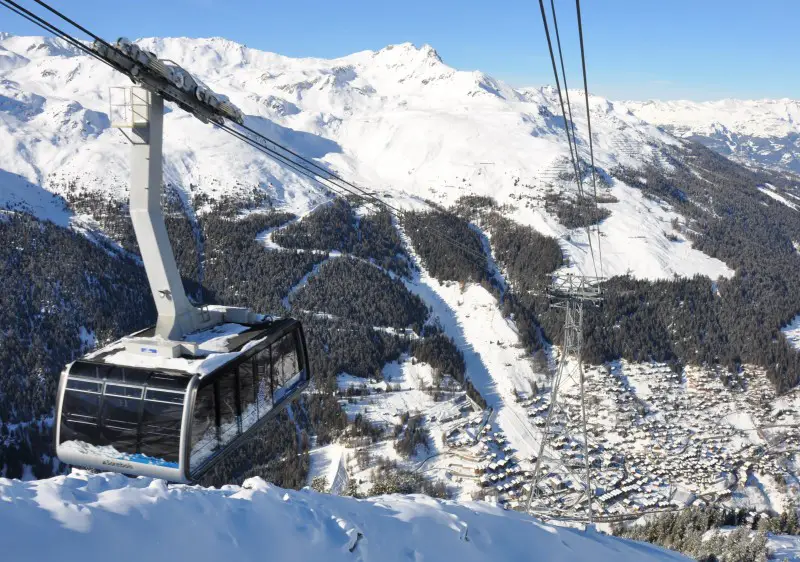A picturesque view of the Grimentz Zinal ski resort in Switzerland's Valais Lemanic Region. Ski lifts a chalet and snow-covered slopes contribute to this captivating winter sports scenery.
