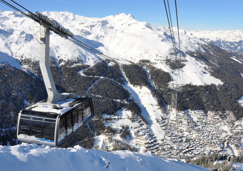 A picturesque view of the Grimentz Zinal ski resort in Switzerland's Valais Lemanic Region. Ski lifts a chalet and snow-covered slopes contribute to this captivating winter sports scenery.