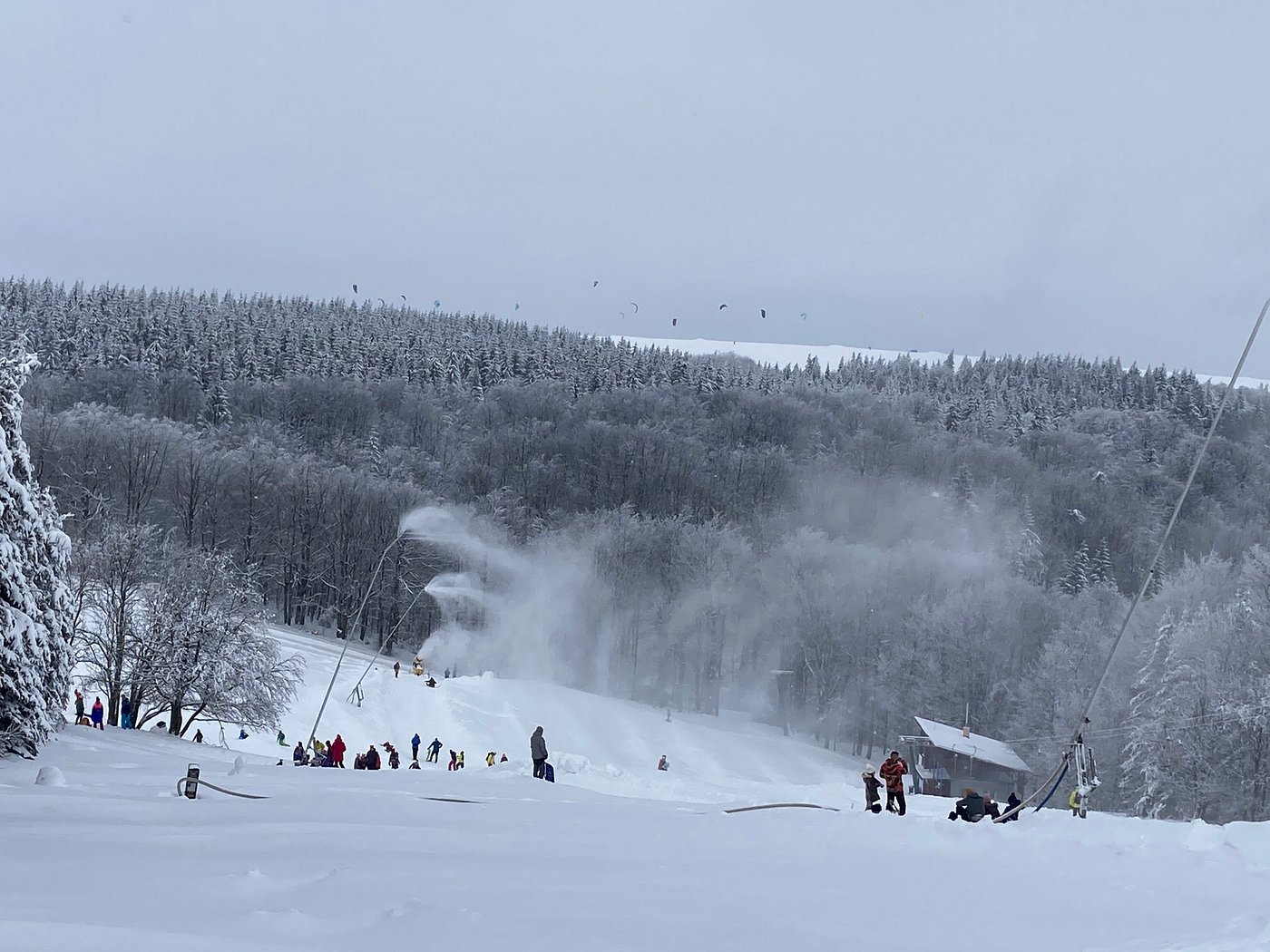 A ski resort in Telnice Czech Republic featuring a winter sports scene with a chalet in the background amidst a stunning winter scenery.