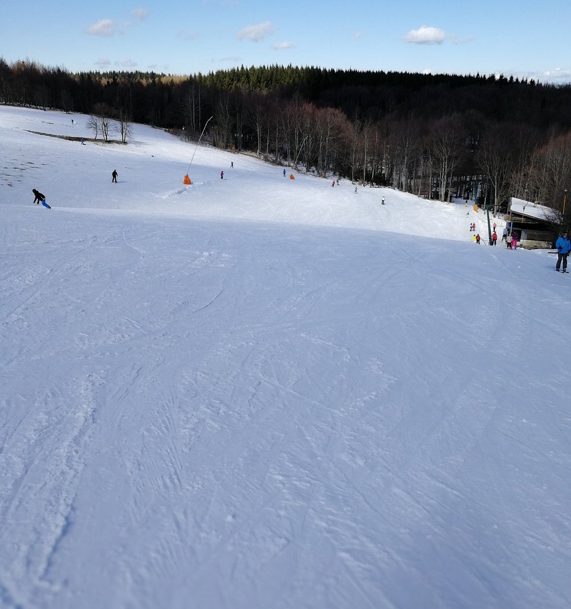 Telnice in Czech Republic - a group of people skiing down a snow covered hill.