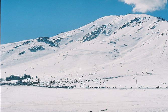 Winter sports scene at Oukaïmeden ski resort in Morocco featuring a charming chalet amidst stunning winter scenery.