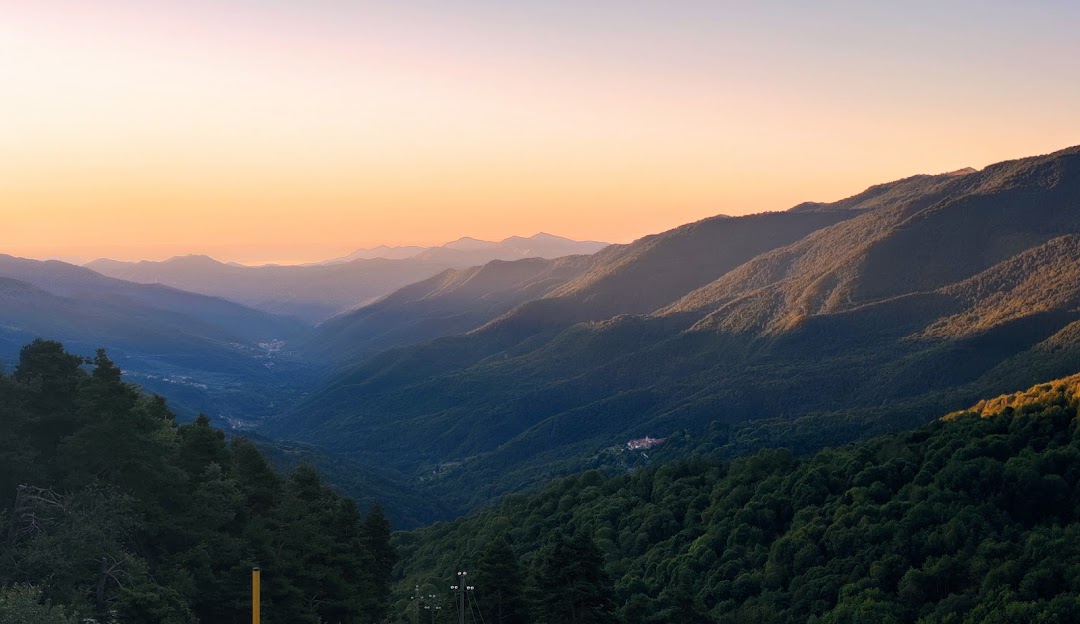 Beautiful winter scenery in Monesi di Tiora, Milan, overlooking the stunning Saccarello Mountain, with a quaint chalet and ski resort visible; a peaceful, snowy Italian landscape.