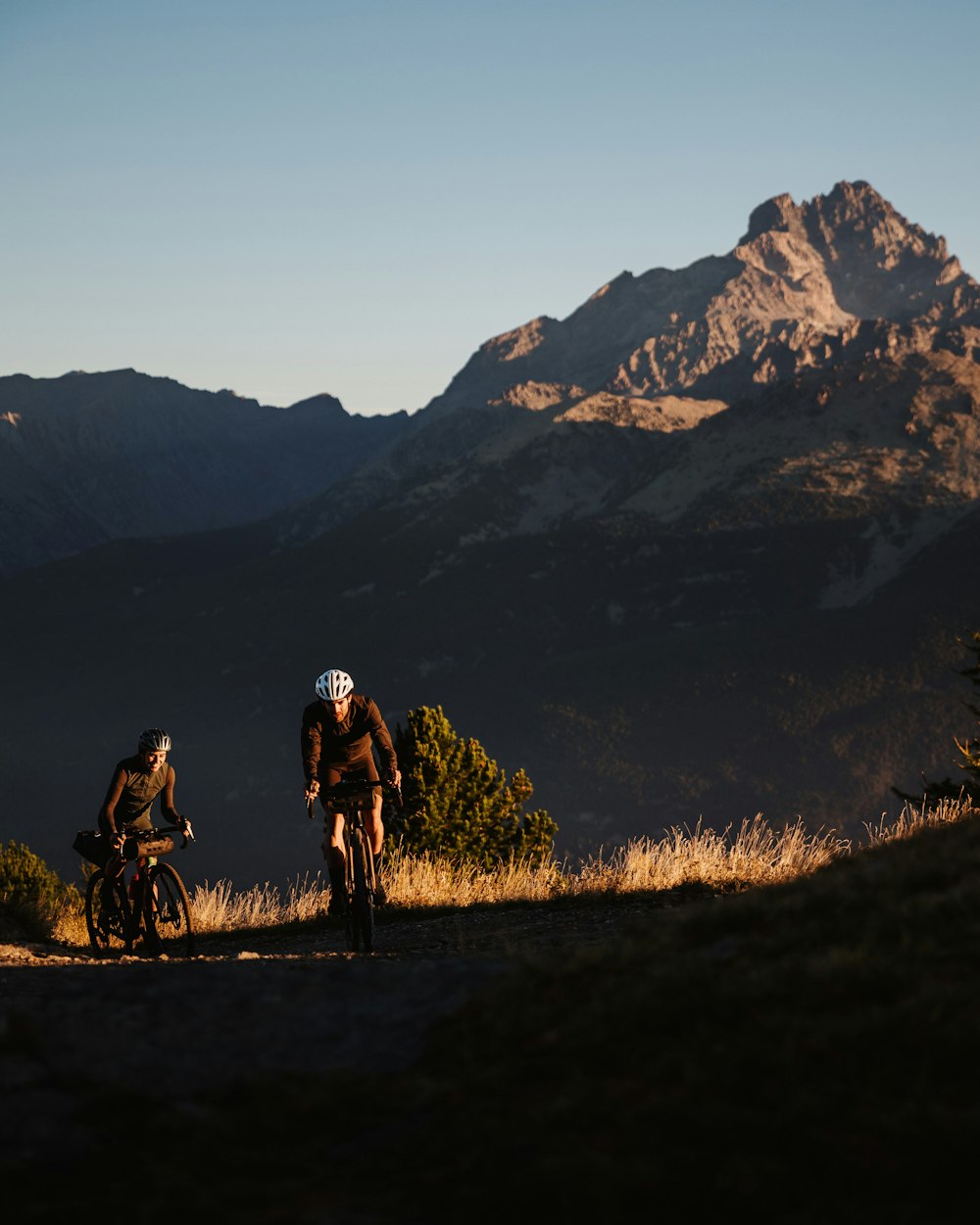 Monesi di Triora in Italy - two people riding bikes on a trail in the mountains.