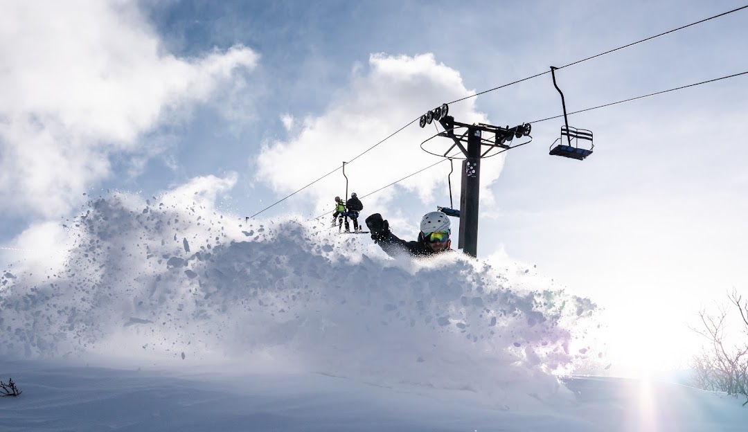 Photo from Hesperus Ski Area in Colorado USA showing a ski lift with potential skiers and snowboarders enjoying winter sports amidst the snowy resort scenery.