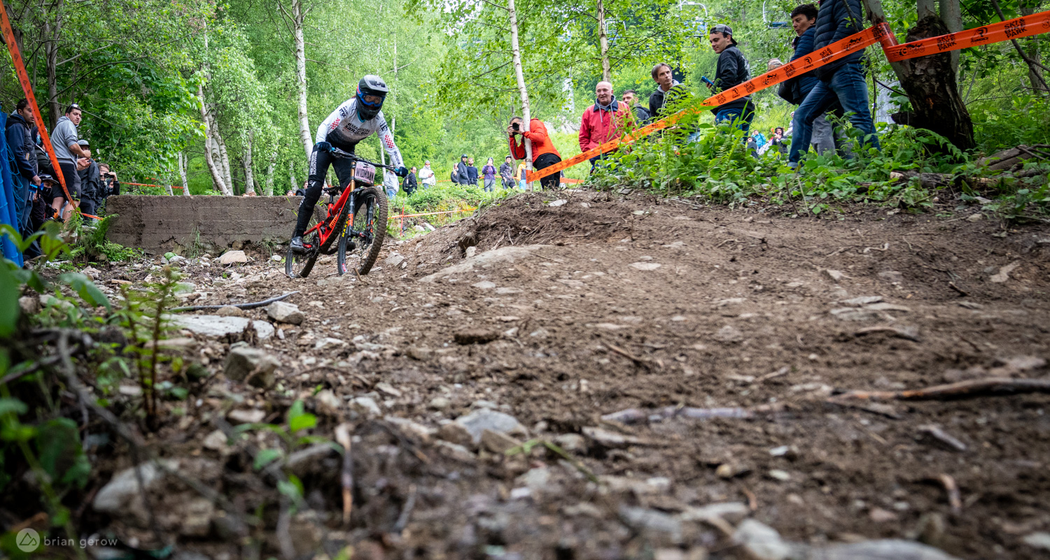 St.Gréé in Italy - a man riding a bike down a dirt hill.