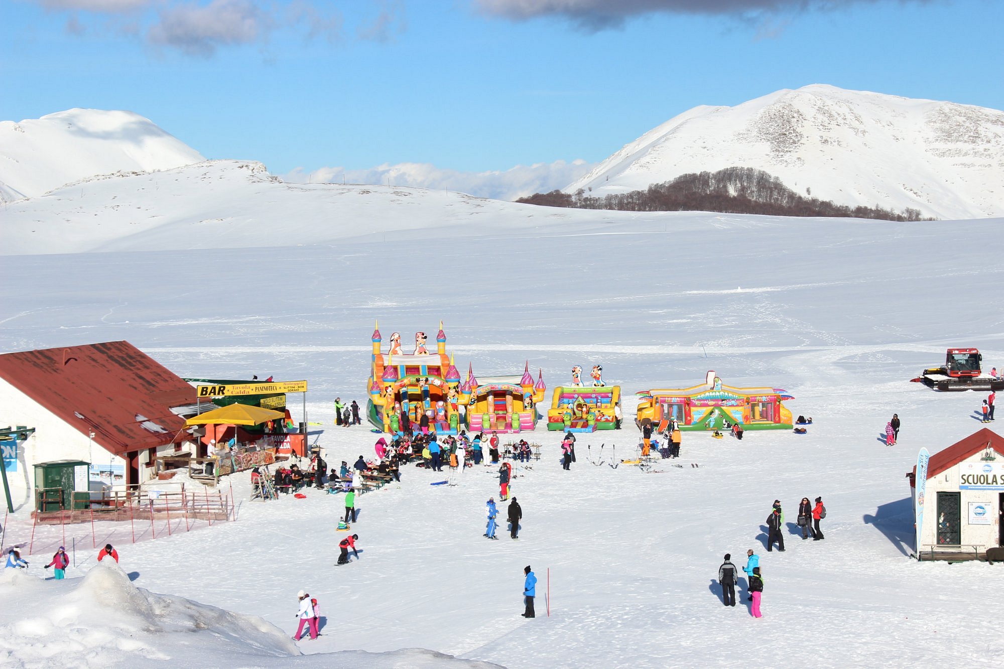 Winter sports enthusiasts enjoying at the Campocatino, a popular ski resort in Frosinone, Italy, amidst breathtaking winter scenery.
