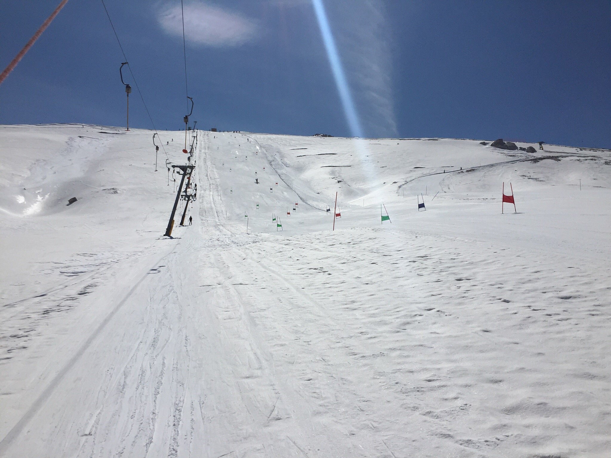 A picturesque view of the Campocatino ski resort in Frosinone Italy showcasing a charming chalet a ski lift and a skier enjoying the winter sports scene.