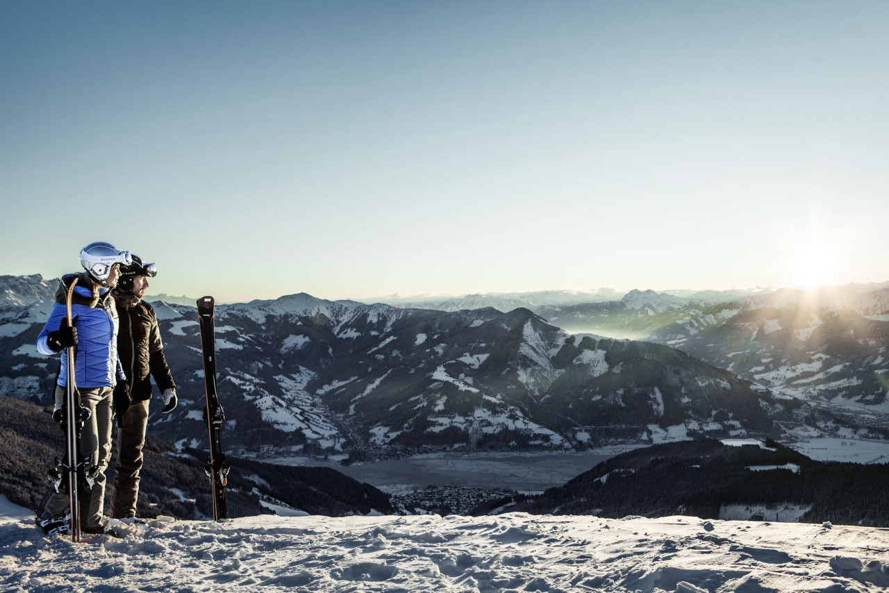 Schmittenhöhe in Austria - a man standing on top of a snow covered mountain.