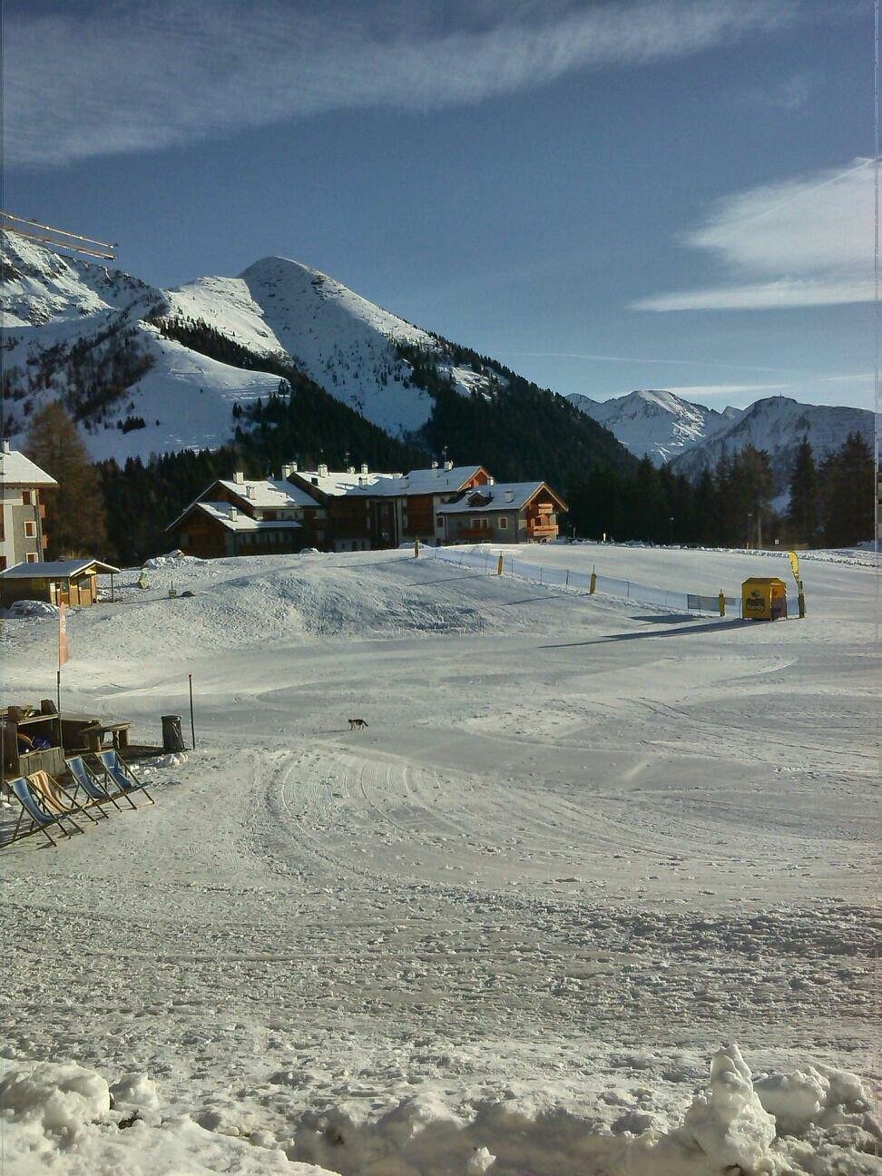 Winter scene at the San Simone ski resort in Lombardy, Italy featuring a charming chalet amidst snow-covered slopes, serving as the hub for various winter sports activities.
