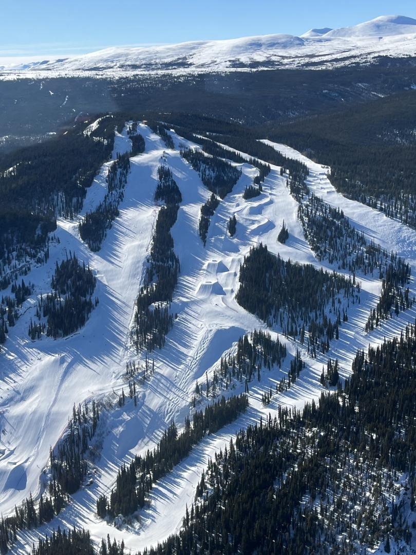 Mount Sima in Canada - a view of a ski slope with trees and snow.