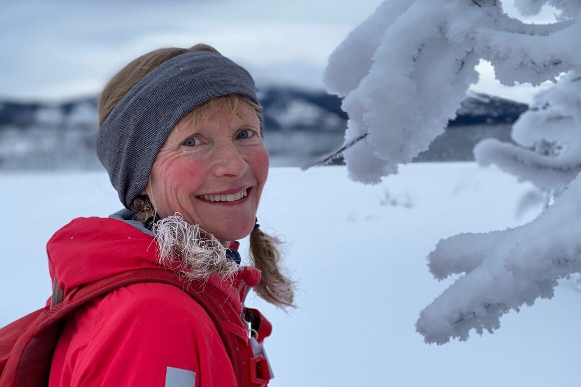 Mount Sima in Canada - a woman in a red jacket standing in the snow.