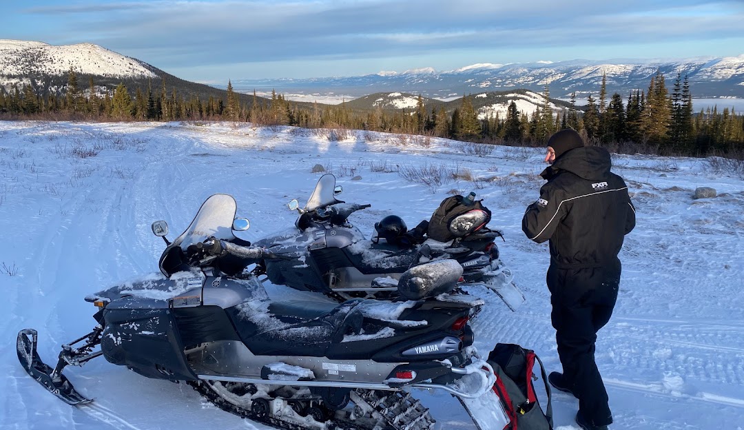 A snowmobile rests on the snowy landscape of Mount Sima in Whitehorse Yukon Canada. Amidst a stunning winter scene the area radiates the charm and excitement typical of a ski resort.