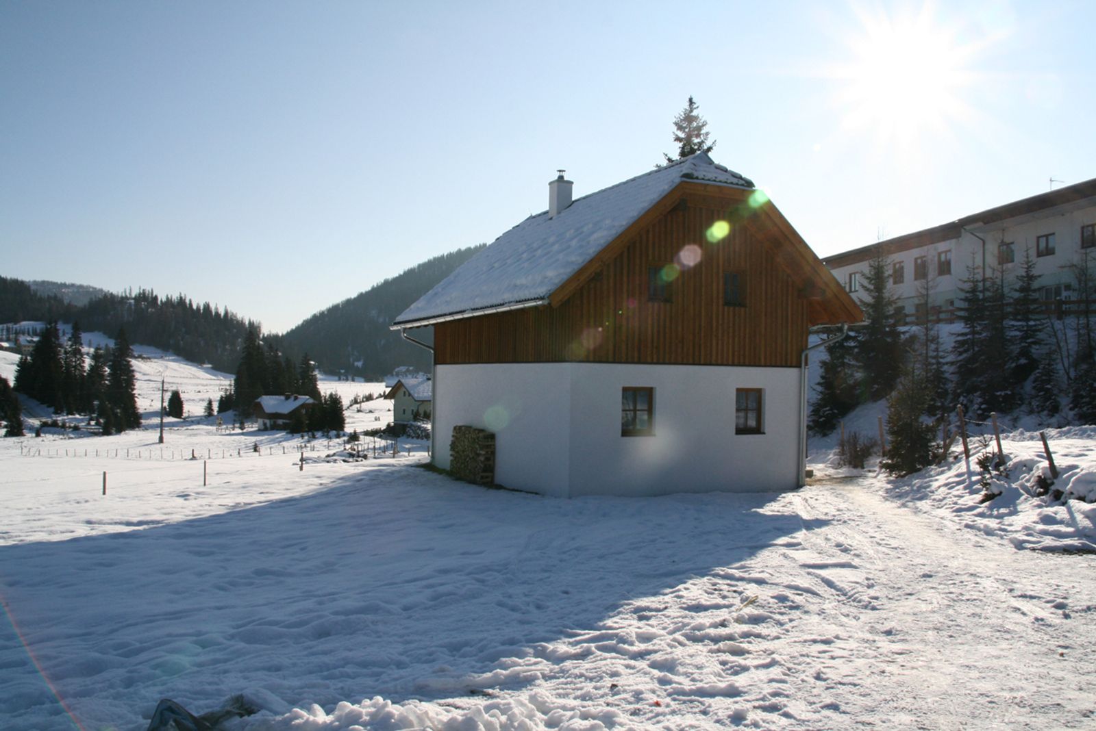 Hirnkopf – Flattnitz in Austria - a small house in the middle of a snowy landscape.