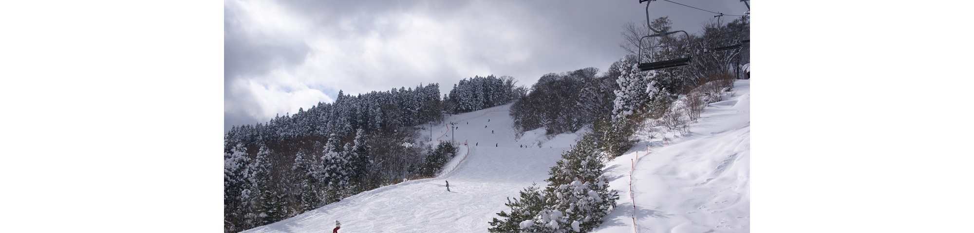 Megahiraonsen Megahira Ski Area in Japan - a person riding a snowboard down a snowy slope.